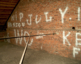 The first portion of historical graffiti on the attic wall.