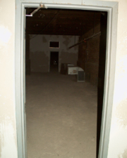 A dark room with nothing more than a single vent.