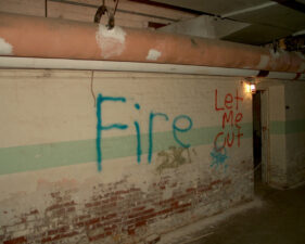 Some graffiti on the basement wall. The fire must not have been too large since there were no signs of fire nearby.