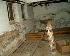 Miscellaneous junk was scattered around in this large basement room.