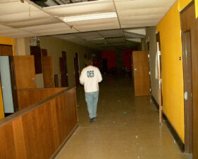An OES member walked down the hallway of a ward that housed the least-threatening "normal" patients.