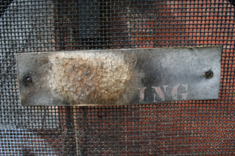 An old sign that probably read "No Smoking" at one time.