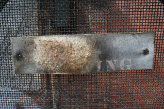 An old sign that probably read "No Smoking" at one time.