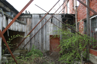 A stairway on the other side of this wall once led to the upstairs office area.