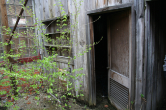 The entrance to a small washroom in the northeast corner.