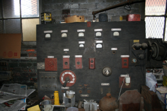 A board with various plugs, gauges, and what appeared to be an old telephone, was in this room.