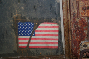 A U.S. flag decal on the door of the receiving office.