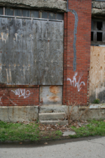 An old doorway where workers could walk across the street to the newer extrusion building.