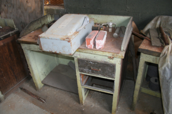Miscellaneous items, including a couple of bricks, on one of the work benches.