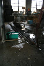 Holes in the roof allowed water to fall onto the shop's floor.