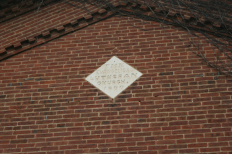 The dedication plaque above the entrance.