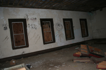 The windows had been boarded up but vandals have since smashed out most of the glass from inside.