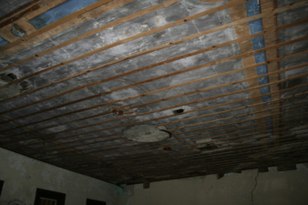 Thin boards striped the ceiling. Perhaps it was once covered with decorative tin or copper panels.