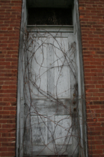 One of the two doors on the front of the church. Men and women used to enter the church through separate doors.