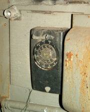 An old rotary phone was on the wall next to the workshop bench.