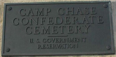 The main plaque outside the cemetery gate lists the cemetery as a U.S. Government Reservation.