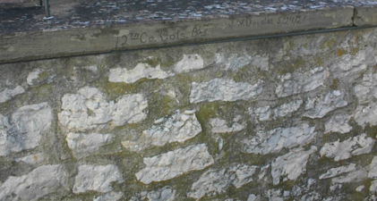 The signature of the stonemason who built the wall that enclosed the cemetery.