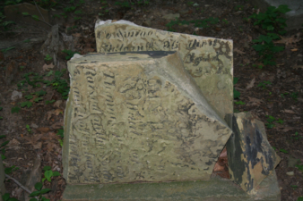 The weathered and broken tombstone of Sarah Hanson.
