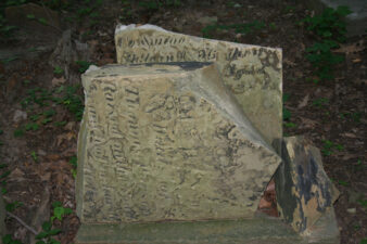 The weathered and broken tombstone of Sarah Hanson.