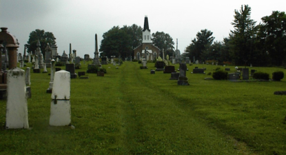 The cemetery's driveway was just tire tracks in the grass.