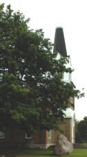 There was a large boulder next to the church.