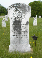 The tombstone of Civil War soldier Jonas Duff. He was a member of Co. A, 40 Ohio Infantry. Notice the cannonballs and flags.