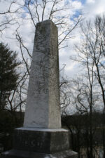 Erected in 1886, the tombstone simply read, "TO THE MEMORY OF OUR DEAD."