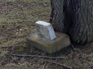 This small tombstone was located at the base of a large tree. Unfortunately, the stone was too worn to make out any details.