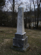 A single tombstone at the south end of the cemetery serves as a monument to all those buried here.