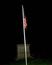 The United States flag with the Civil War memorial in the background.