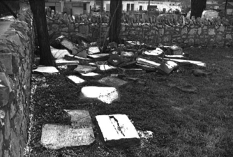 This old photo shows that many broken tombstones were piled in a corner of the cemetery many years ago.