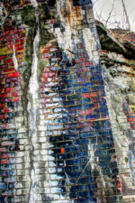 An old piece of telegraph wire hanging from the tunnel's wall.