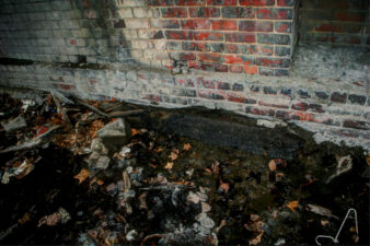 This railroad tie was surrounded by mud and litter.