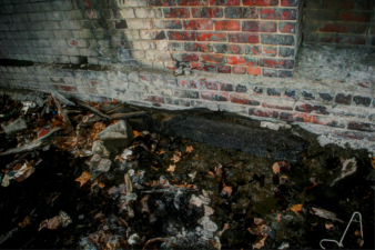 This railroad tie was surrounded by mud and litter.