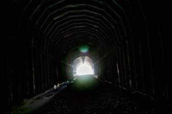 A view from the large wooden center section toward the bricked section of the tunnel.