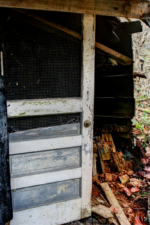 The front screen door of the shack building.