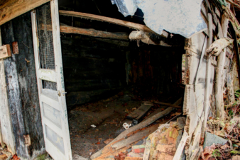 Notice the hand-hewn pieces of wood inside the shack.