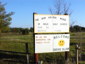 The New Golden Wedge Golf Course sign at the entrance to the course.