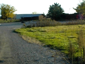The gravel driveway led to the parking lot and club house.