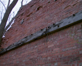 Wooden beams attached to the wall from the previous photo.
