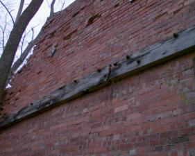 Wooden beams attached to the wall from the previous photo.