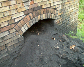 A pile of black soot poured from the bottom of the stack.