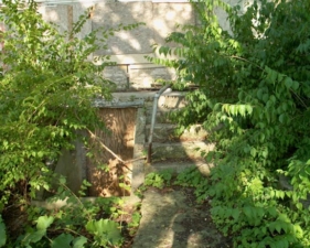 The boarded up entry to the basement.