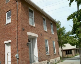 An angled view of the Harrison House. The side windows were added later.