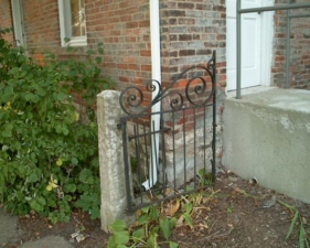 A part of an old gate on the back side of the house.