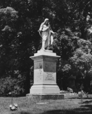 This tombstone with Jesus on top was missing its finger in this 1957 photo.