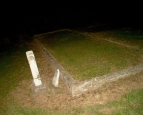There were two tombstones just outside the walled section.