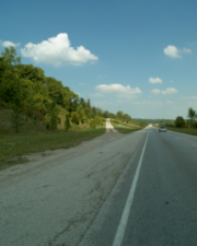 The gravel path to the left went up the hill to the abandoned rest area.
