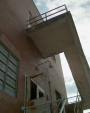 Going up the stairs at one end of the building to the top floor.