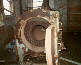 Some kind of heavy machinery in the same room as the furnaces.